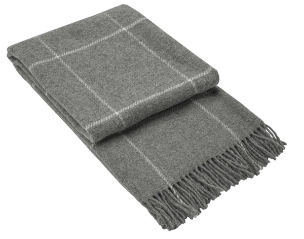 Brighton Throw blanket made from 100% New Zealand wool in a stylish grey striped pattern, draped elegantly over a sofa.