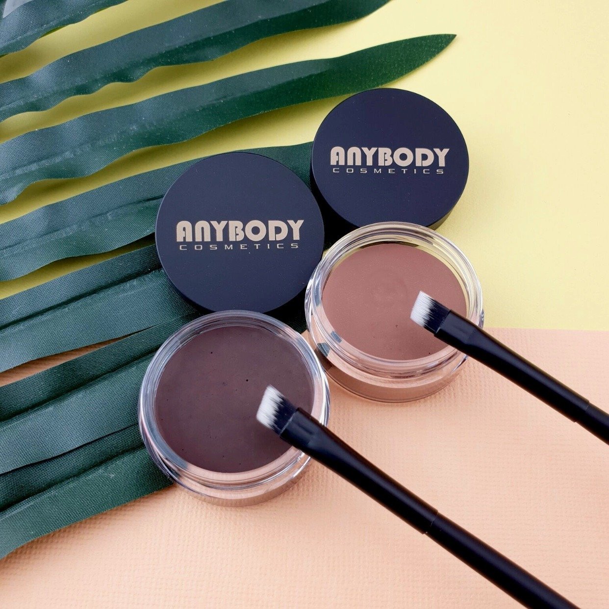 A sleek container of Brow Wax Dark Shade, showcasing its dark color and easy application stick design, ideal for sculpting brows.