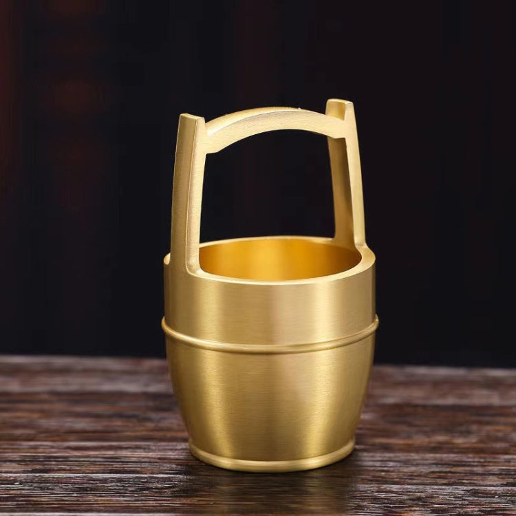 A hand polished brass mini ornament shaped like a bucket, symbolizing wealth and prosperity, perfect for office or home decor.