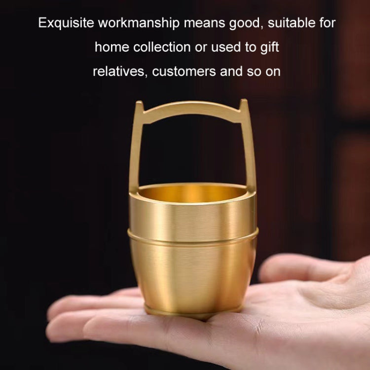 A hand polished brass mini ornament shaped like a bucket, symbolizing wealth and prosperity, perfect for office or home decor.