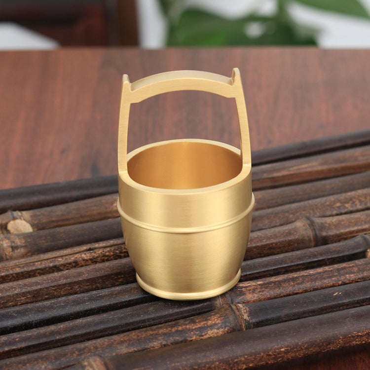 A hand polished brass mini ornament shaped like a bucket, symbolizing wealth and prosperity, perfect for office or home decor.