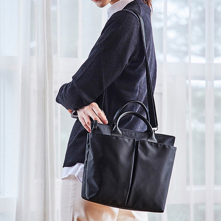 Business Briefcase Handbag in black oxford cloth, showcasing dual-purpose design with shoulder strap and anti-theft magnetic buckle.