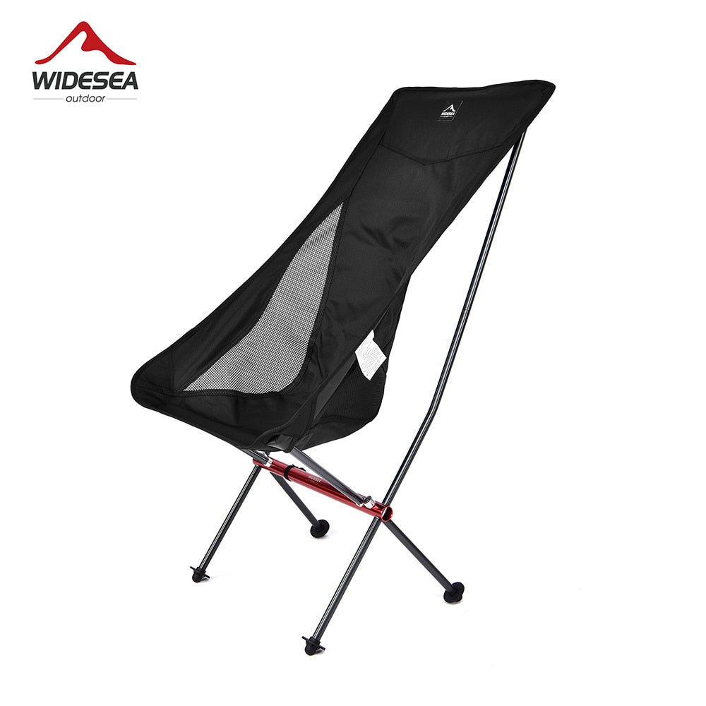 A lightweight and portable Camping Fishing Folding Chair set up on a sandy beach, showcasing its durable fabric and sturdy frame.