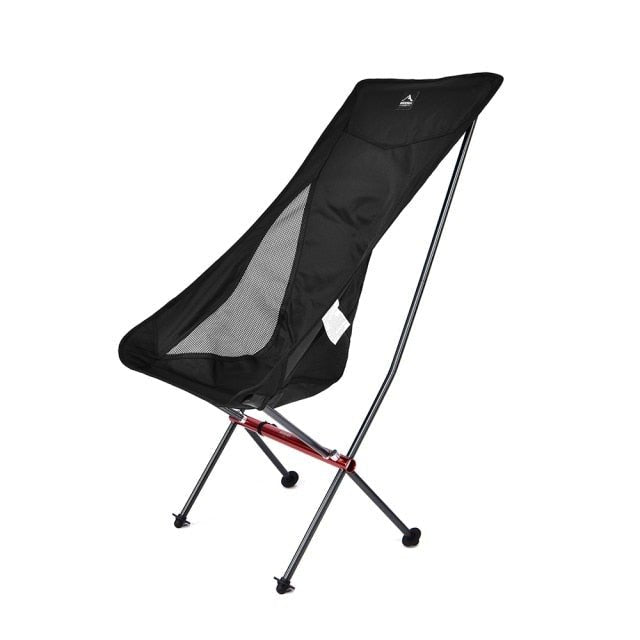 A lightweight and portable Camping Fishing Folding Chair set up on a sandy beach, showcasing its durable fabric and sturdy frame.