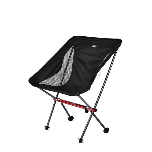 A lightweight and portable Camping Fishing Folding Chair set up on a sandy beach, showcasing its durable fabric and sturdy frame.