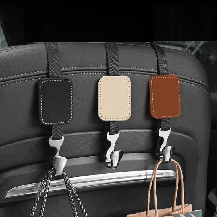 Beige suede multifunctional hook for car rear seat backrest, showcasing its durable design and compact size.