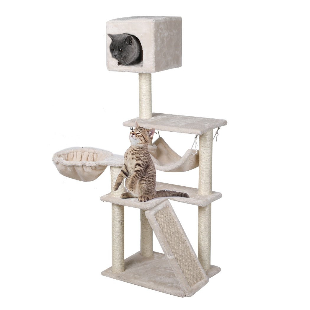 A beige multi-level cat tree tower with plush covering, sisal scratching posts, and hanging toys, designed for playful cats.