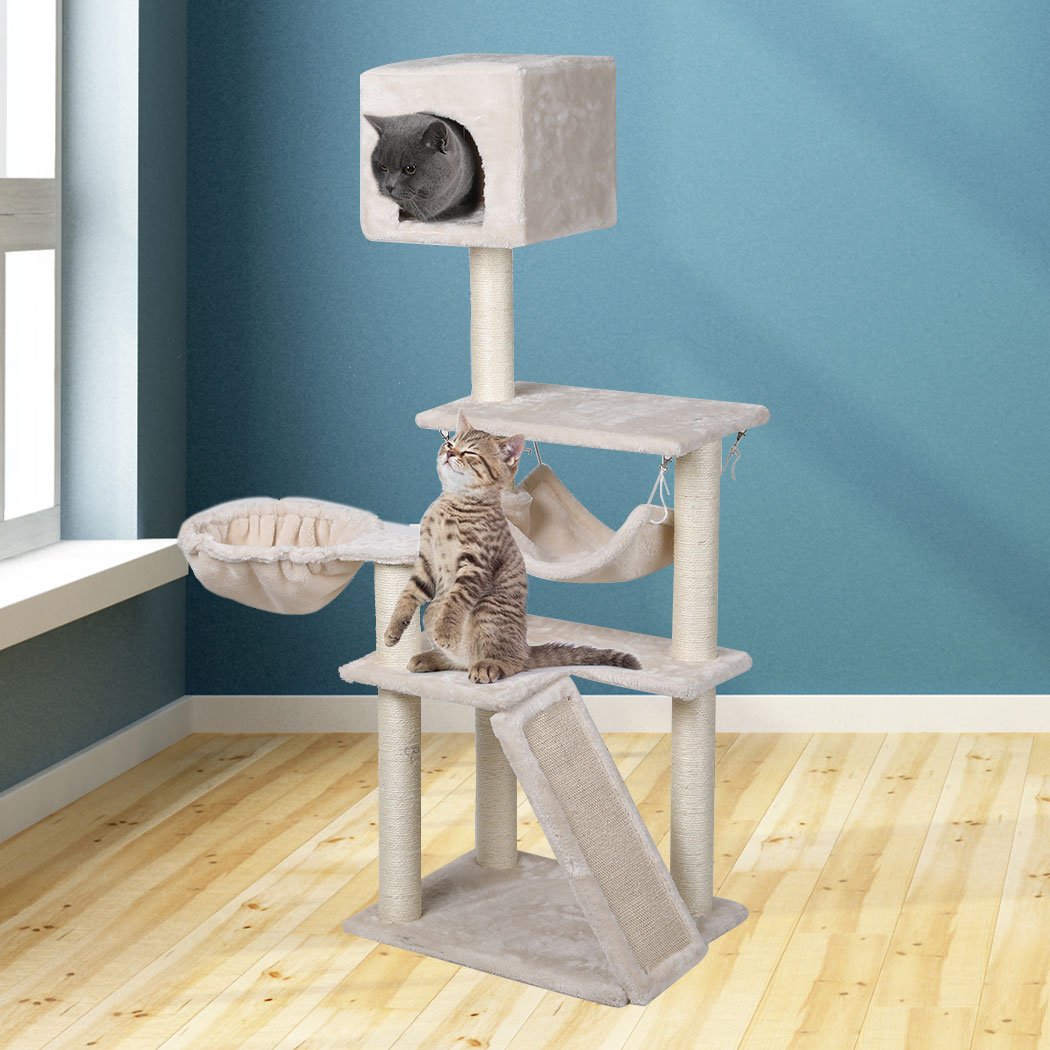 A beige multi-level cat tree tower with plush covering, sisal scratching posts, and hanging toys, designed for playful cats.