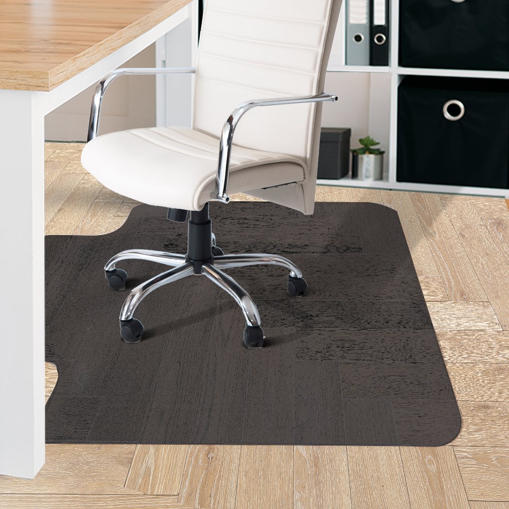 Black Chair Mat designed for hard floors and carpets, featuring a notched stud design for grip and protection against scratches.