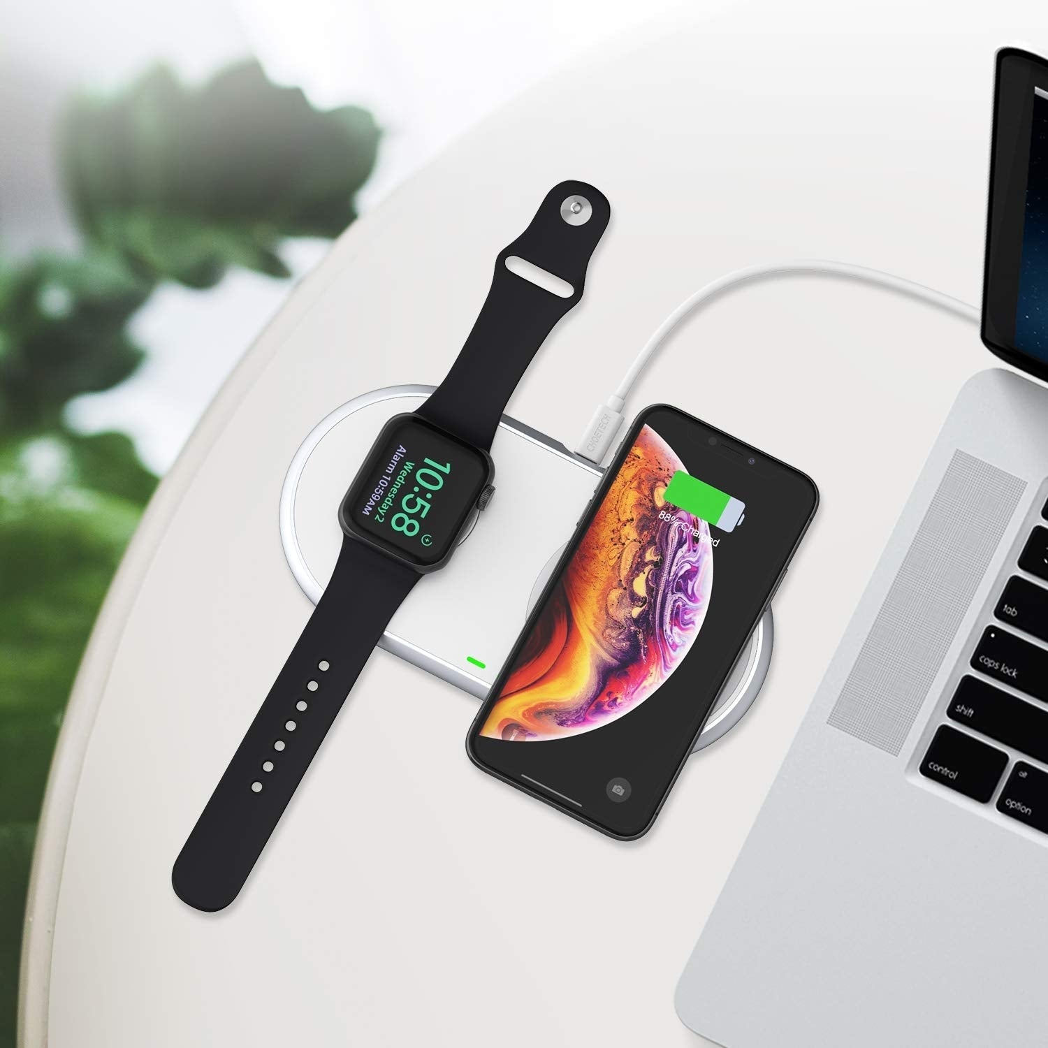 CHOETECH T317 2-in-1 Dual Wireless Charger Pad with iPhone, Apple Watch, and AirPods charging simultaneously on a stylish zinc-alloy surface.