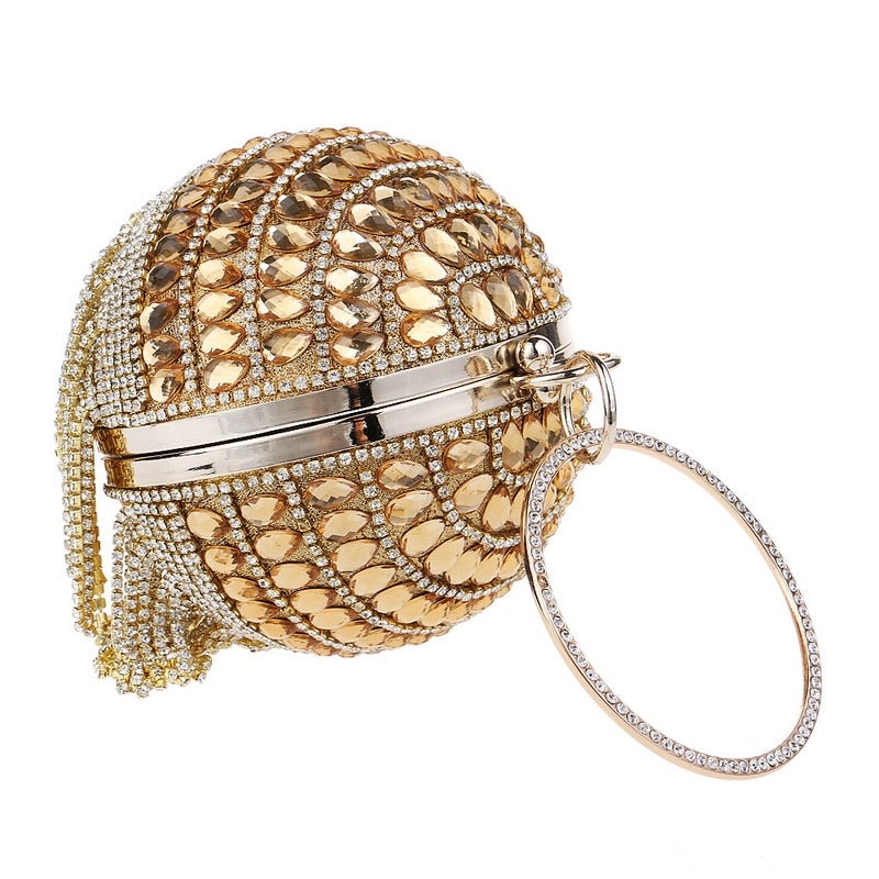 Circular women clutch with tassels and rhinestones, featuring a stylish design and chain shoulder strap, perfect for evening events.