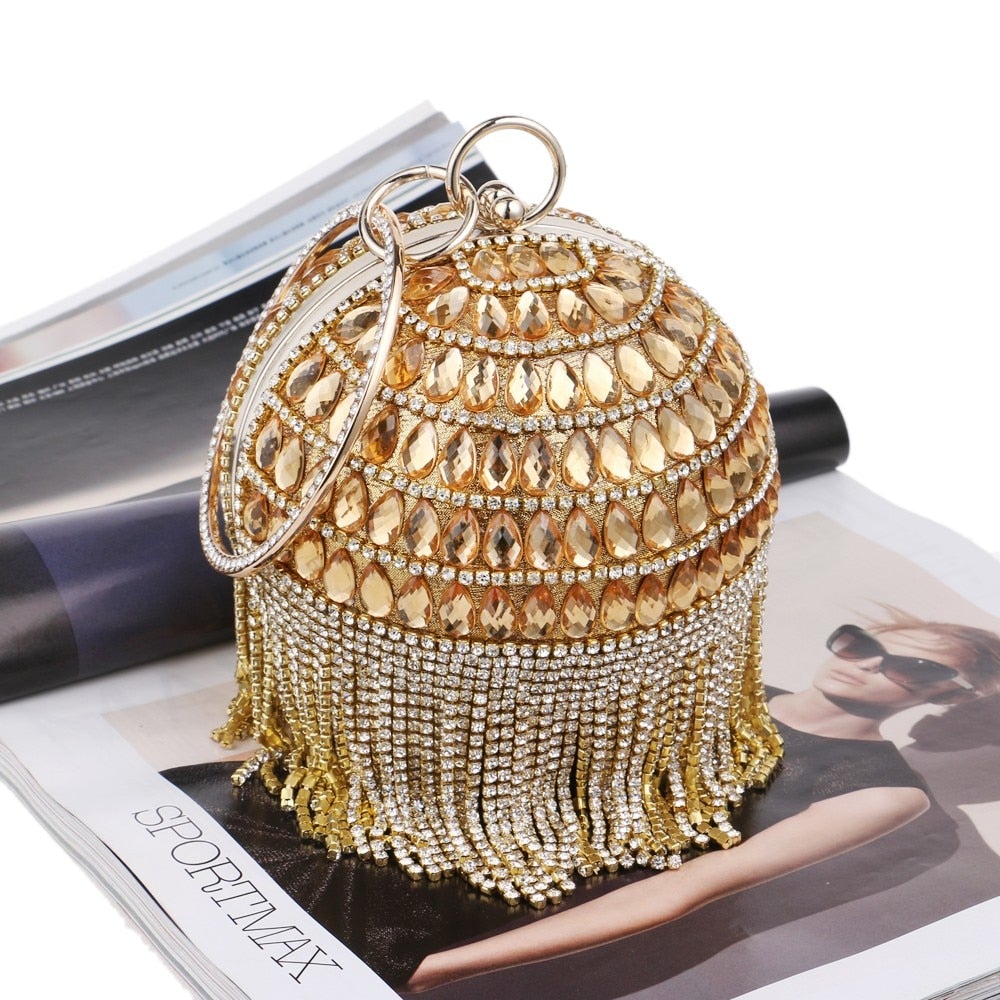 Circular women clutch with tassels and rhinestones, featuring a stylish design and chain shoulder strap, perfect for evening events.