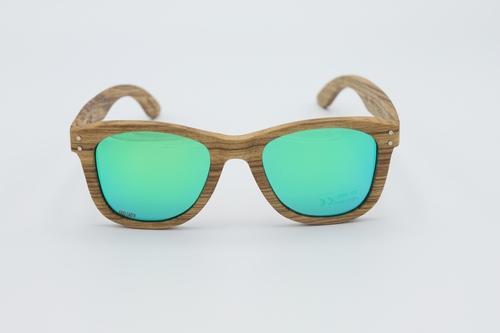 Classic sunglasses with zebra wood frames and polarized green lenses, displayed in a stylish wood box with microfiber accessories.