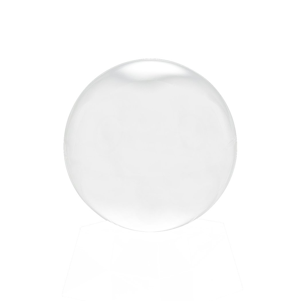 A clear glass healing crystal ball sphere, perfect for photography and home decor, displayed on a wooden surface with soft lighting.