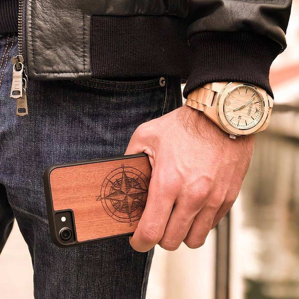 A beautifully crafted Mahogany wooden phone case, showcasing its unique grain and finish, held in a hand against a natural backdrop.