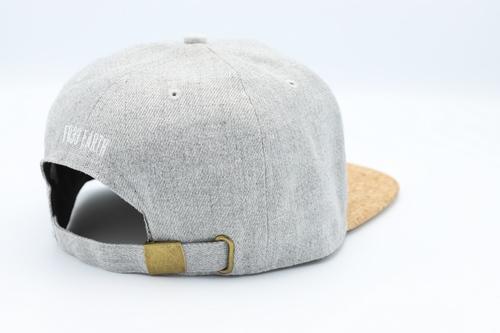 Stylish grey cork cap with rustic buckle, perfect for sun protection.