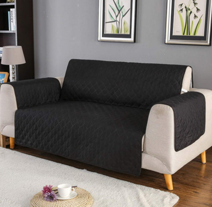 Reversible black and red couch cover protector for 2-seater sofas, featuring a quilted design and anti-slip backing.