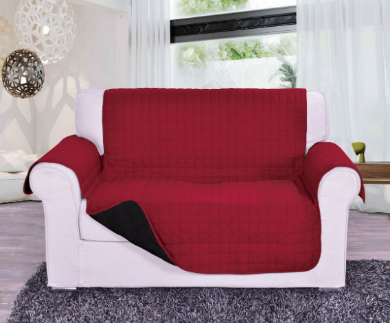 Reversible black and red couch cover protector for 2-seater sofas, featuring a quilted design and anti-slip backing.