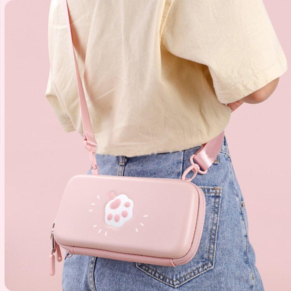 Cute pink cat bag designed for Nintendo Switch and Switch Lite, featuring hand and shoulder straps for easy carrying.