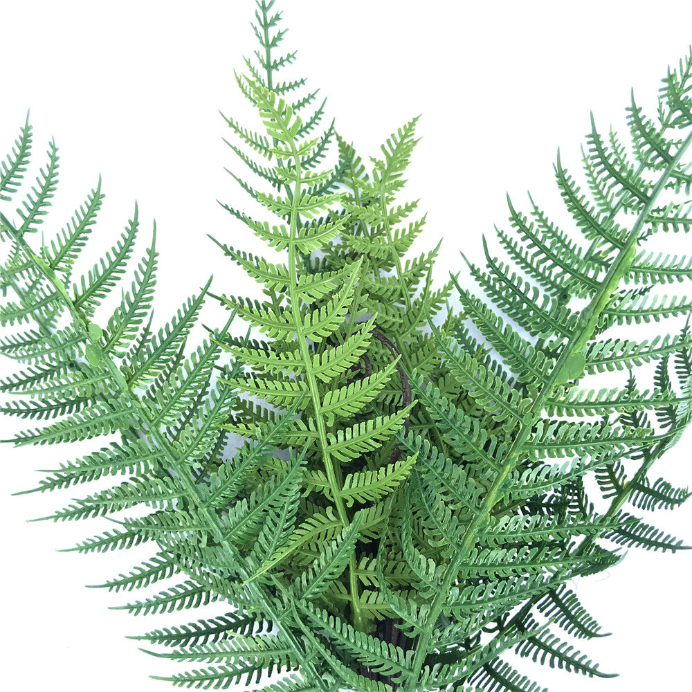 A 38cm dark green artificial fern stem, UV resistant, perfect for floral arrangements and vertical gardens.