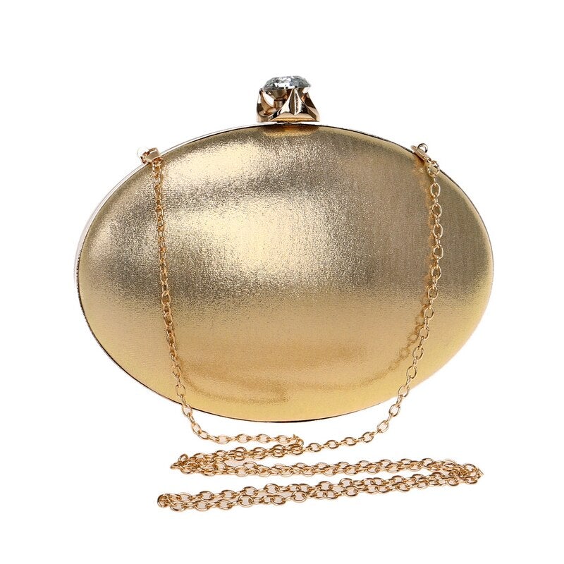 Elegant egg-shaped clutch for women adorned with rhinestones and a chain shoulder strap, perfect for evening events.