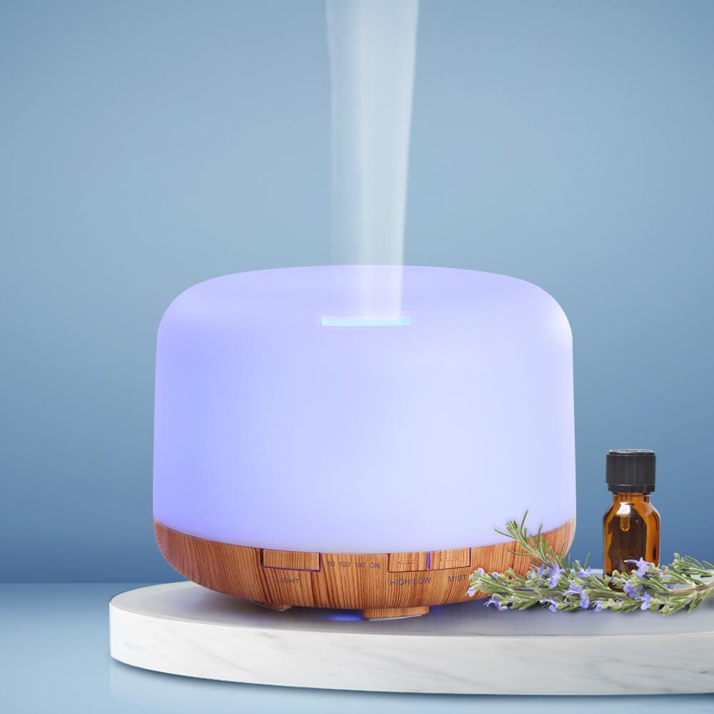 DEVANTI Aroma Diffuser with LED night light and wood base, showcasing its modern design and features.