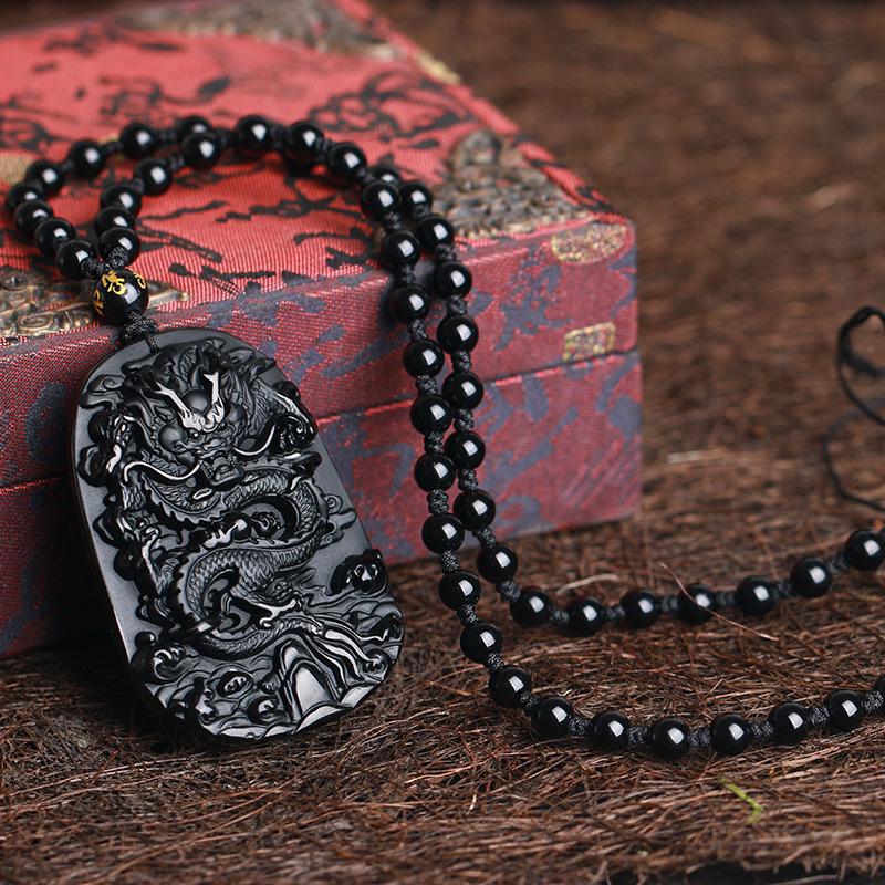 Hand-carved black obsidian dragon pendant necklace, symbolizing protection and wealth attraction.