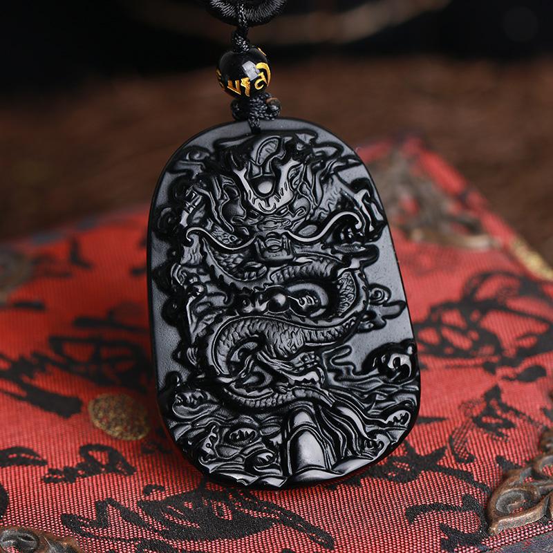 Hand-carved black obsidian dragon pendant necklace, symbolizing protection and wealth attraction.