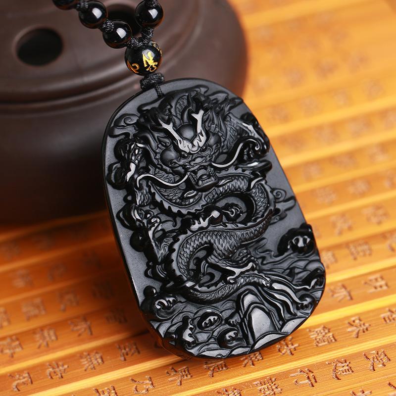 Hand-carved black obsidian dragon pendant necklace, symbolizing protection and wealth attraction.