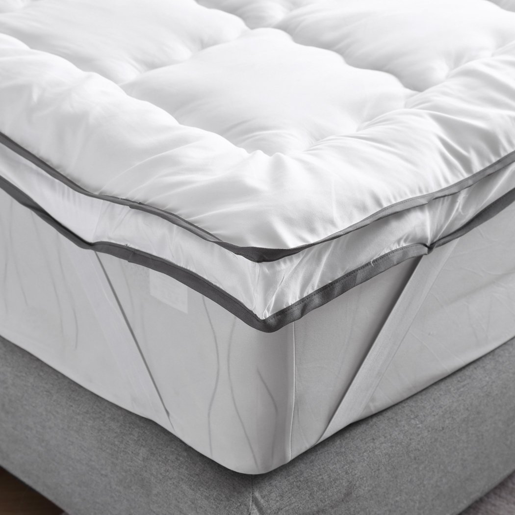 DreamZ Luxury Bedding Pillowtop Mattress Topper in white, showcasing its plush 5cm thickness and sewn pockets for even filling distribution.