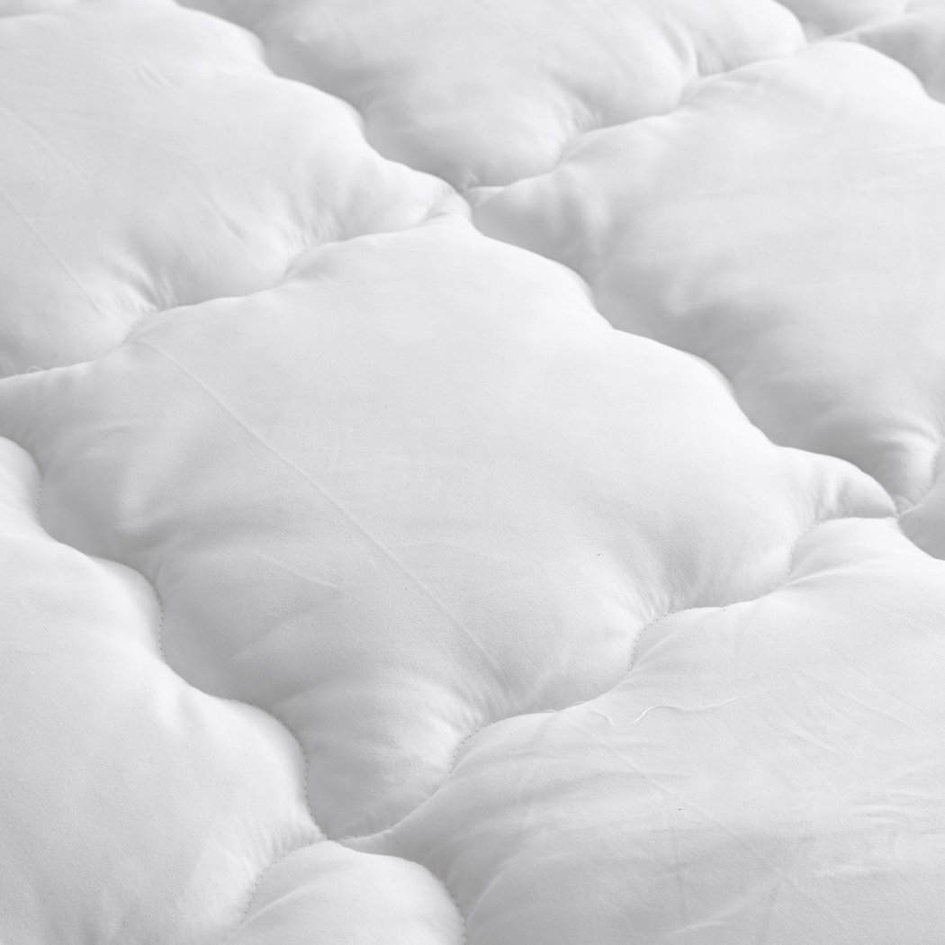 DreamZ Luxury Bedding Pillowtop Mattress Topper in white, showcasing its plush 5cm thickness and sewn pockets for even filling distribution.