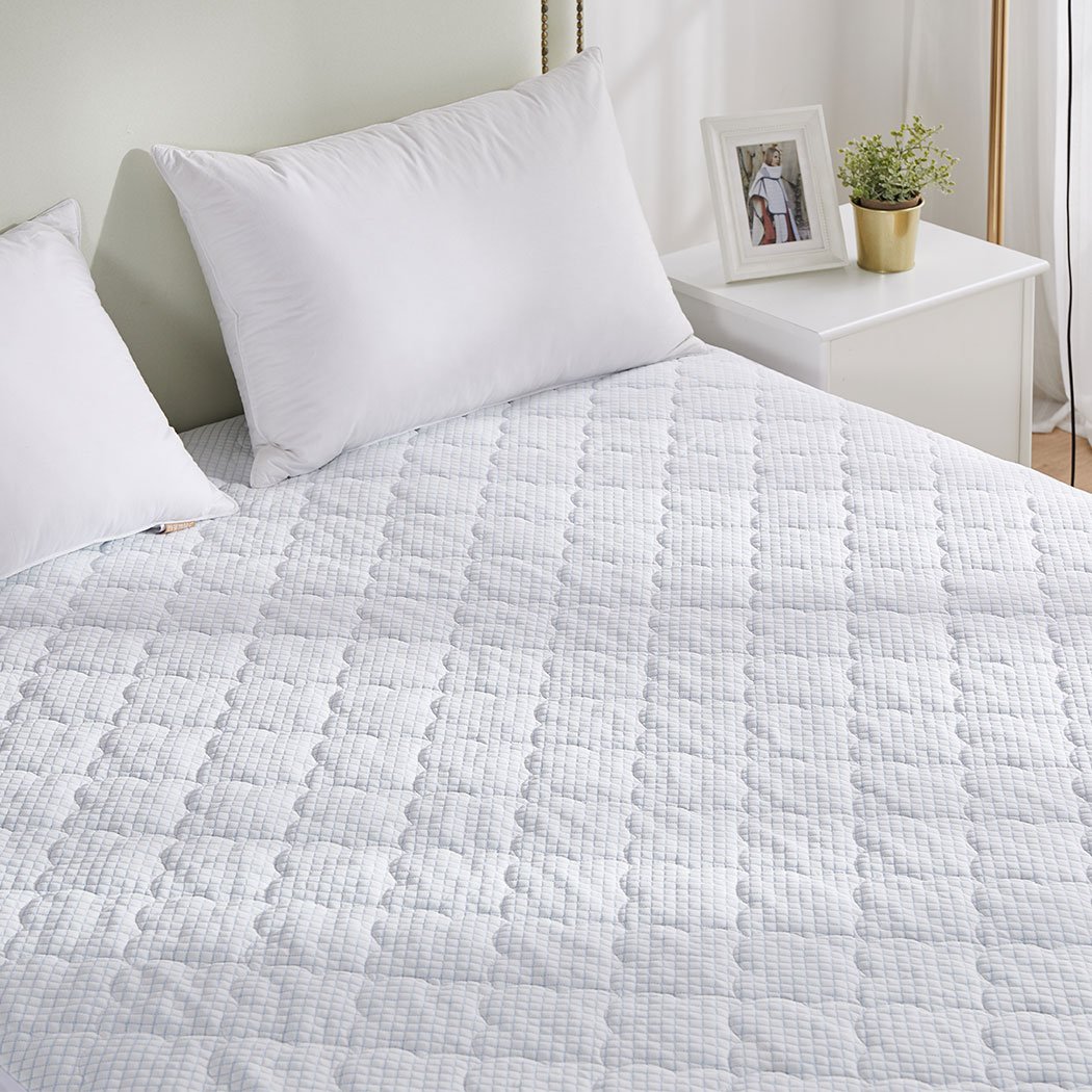 Dreamz Mattress Protector Topper in white, showcasing cool fabric and plush pillowtop design, perfect for king-sized beds.