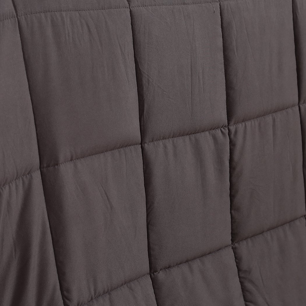 DreamZ Weighted Blanket in grey color, featuring a soft polyester exterior and glass bead filling for deep relaxation.