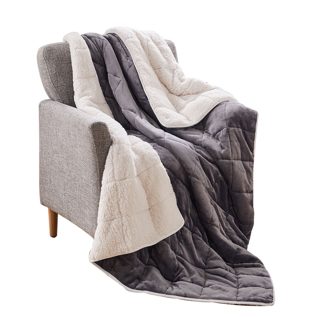 DreamZ Weighted Blanket in grey and white, showcasing its soft fleece and flannel sides, designed for deep relaxation and comfort.