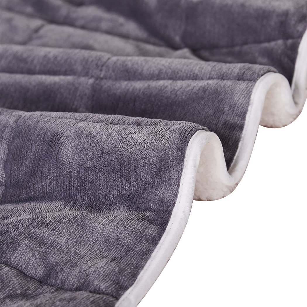 DreamZ Weighted Blanket in grey and white, showcasing its soft fleece and flannel sides, designed for deep relaxation and comfort.