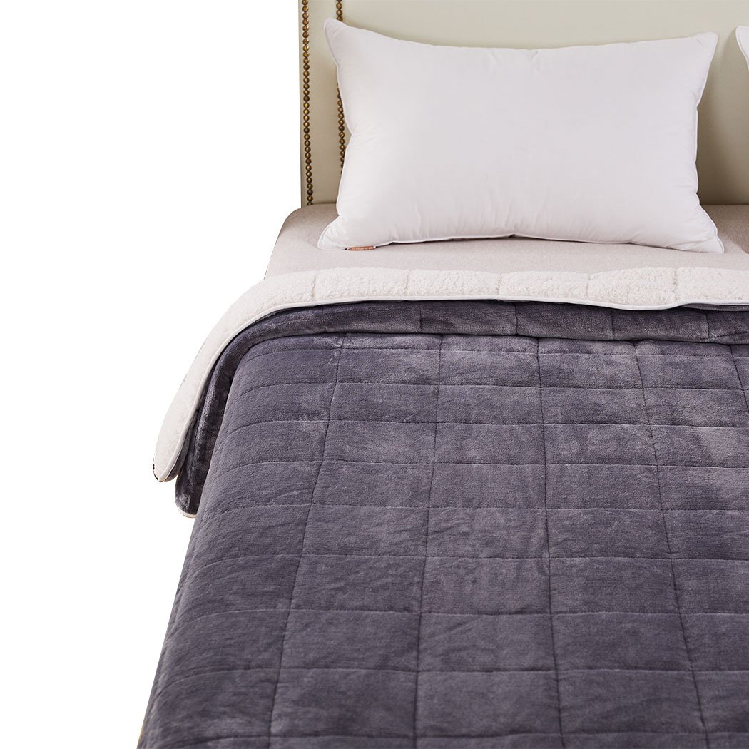 DreamZ Weighted Blanket in grey and white, showcasing its soft fleece and flannel sides, designed for deep relaxation and comfort.