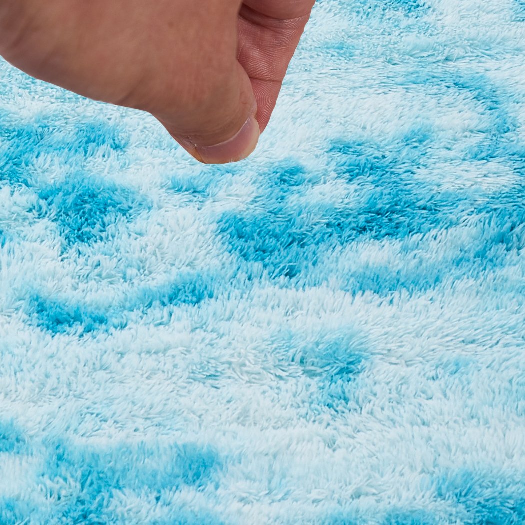 Soft shaggy tie-dyed floor rug in vibrant colors, perfect for home decor and comfort.