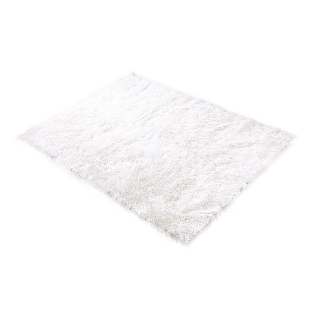 Luxurious white sheepskin shaggy rug with a plush 60-70mm pile, perfect for enhancing comfort in living rooms and bedrooms.