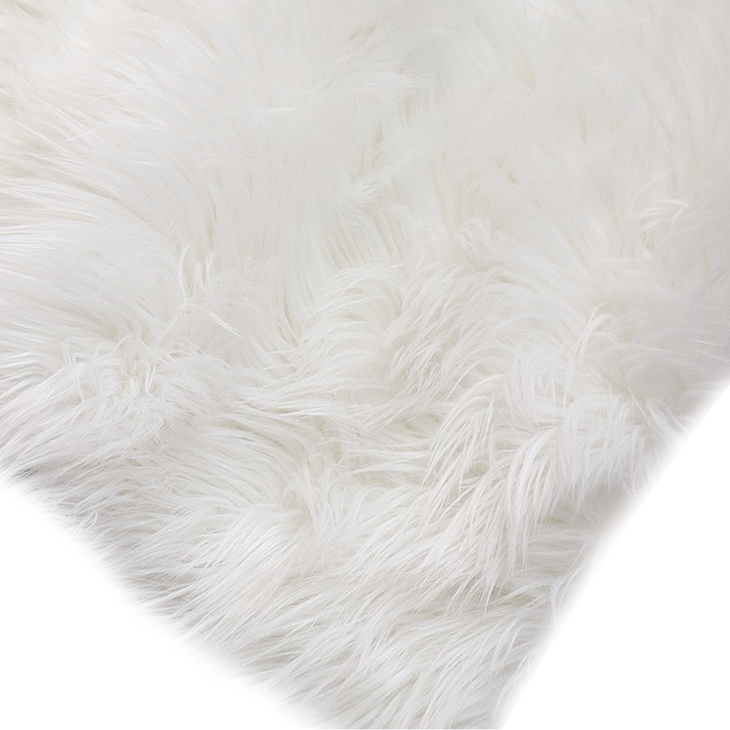 Luxurious white sheepskin shaggy rug with a plush 60-70mm pile, perfect for enhancing comfort in living rooms and bedrooms.