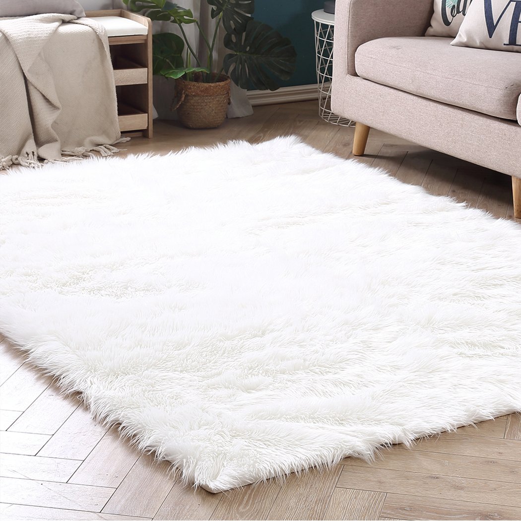 Luxurious white sheepskin shaggy rug with a plush 60-70mm pile, perfect for enhancing comfort in living rooms and bedrooms.