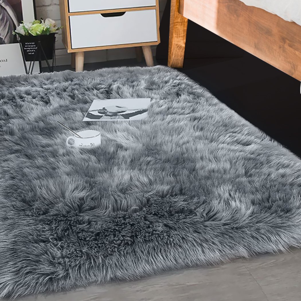 Luxurious dark grey sheepskin shaggy rug measuring 60x120 cm, perfect for bedroom or living room decor.