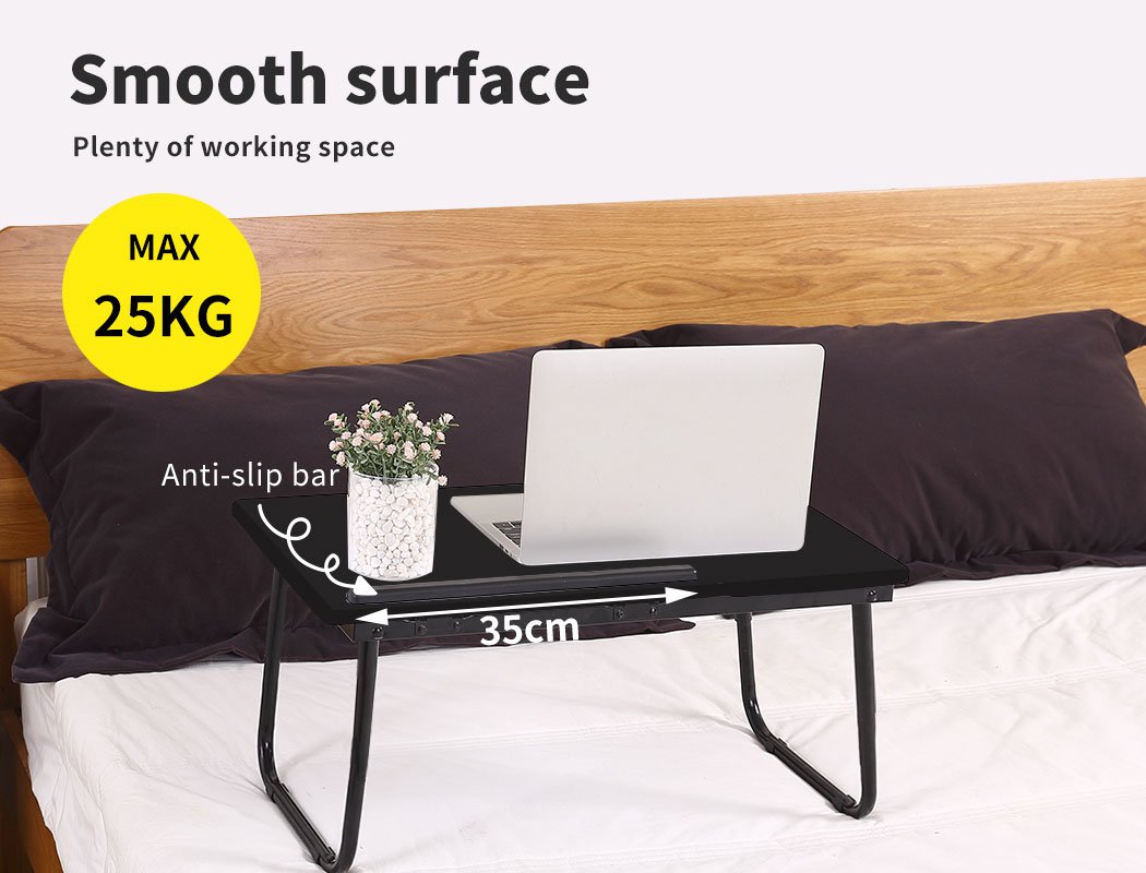 Foldable bed tray laptop table in black, featuring a smooth surface and foldable legs for easy storage and portability.