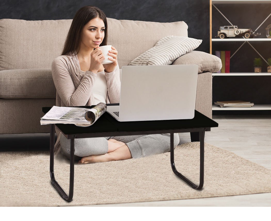 Foldable bed tray laptop table in black, featuring a smooth surface and foldable legs for easy storage and portability.