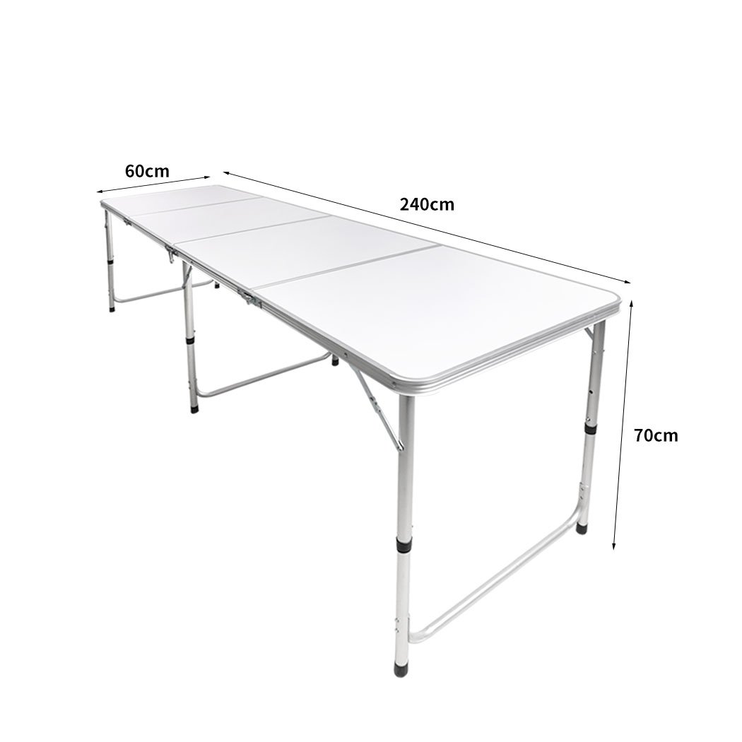 A lightweight and portable folding camping table set up outdoors, showcasing its sturdy aluminum frame and smooth MDF tabletop.