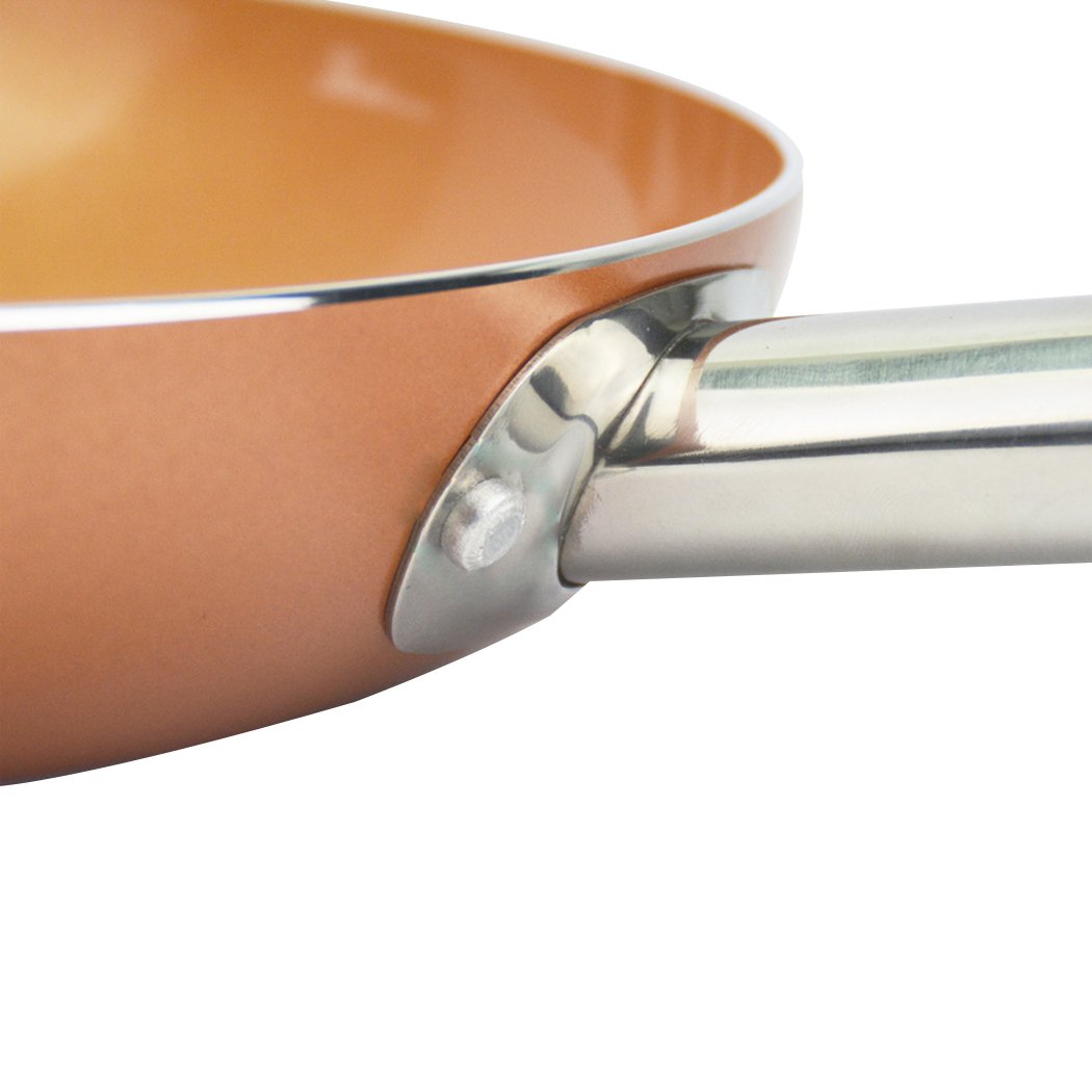 A sleek non-stick stainless steel frying pan with a copper-infused surface, ideal for healthy cooking.