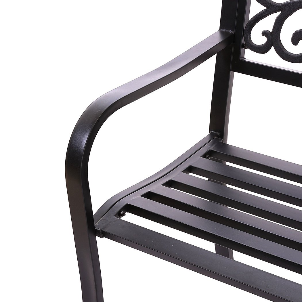 A stylish black garden bench made of galvanized steel and cast iron, featuring a floral backrest and smooth armrests, perfect for outdoor relaxation.