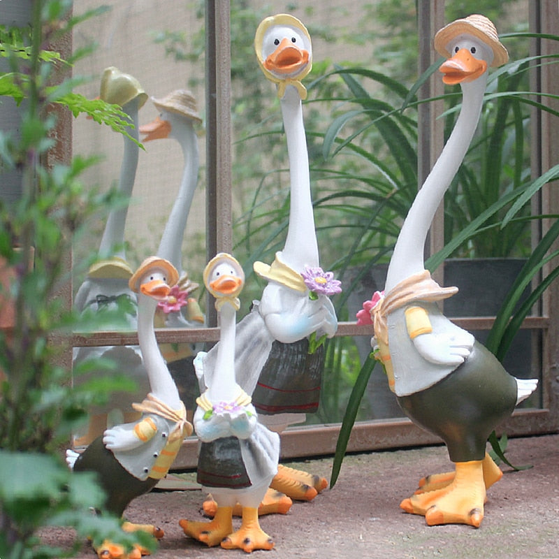 A charming resin duck family figurine set, perfect for garden decoration, showcasing intricate details and vibrant colors.