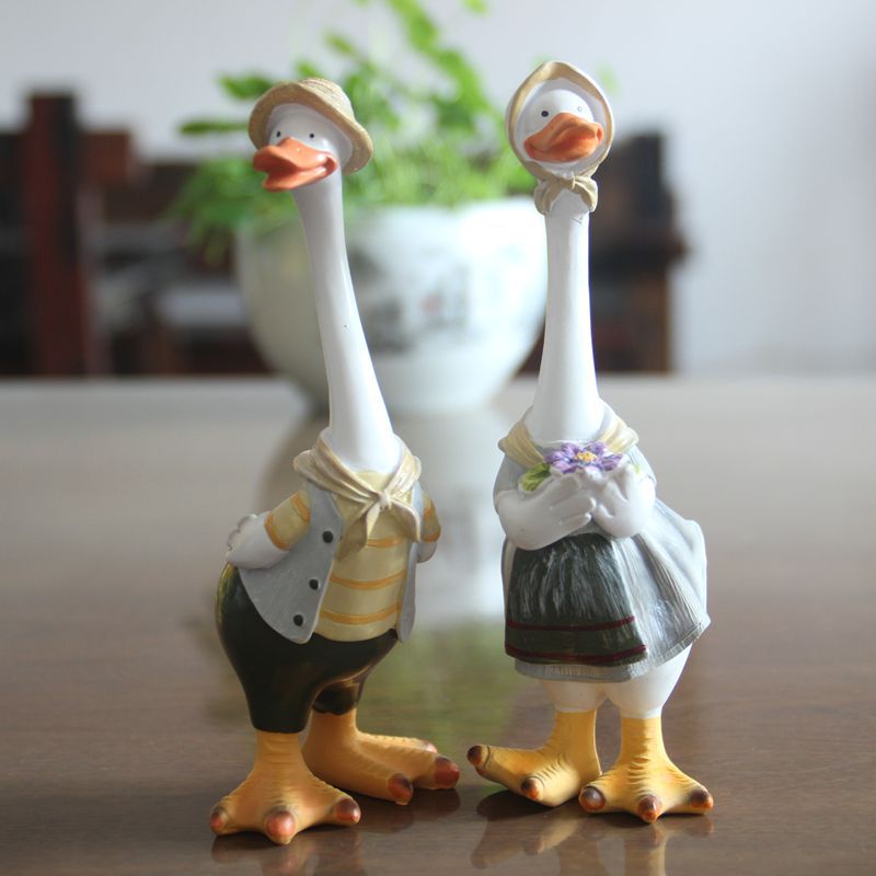 A charming resin duck family figurine set, perfect for garden decoration, showcasing intricate details and vibrant colors.