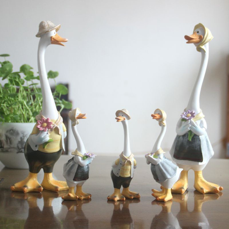 A charming resin duck family figurine set, perfect for garden decoration, showcasing intricate details and vibrant colors.