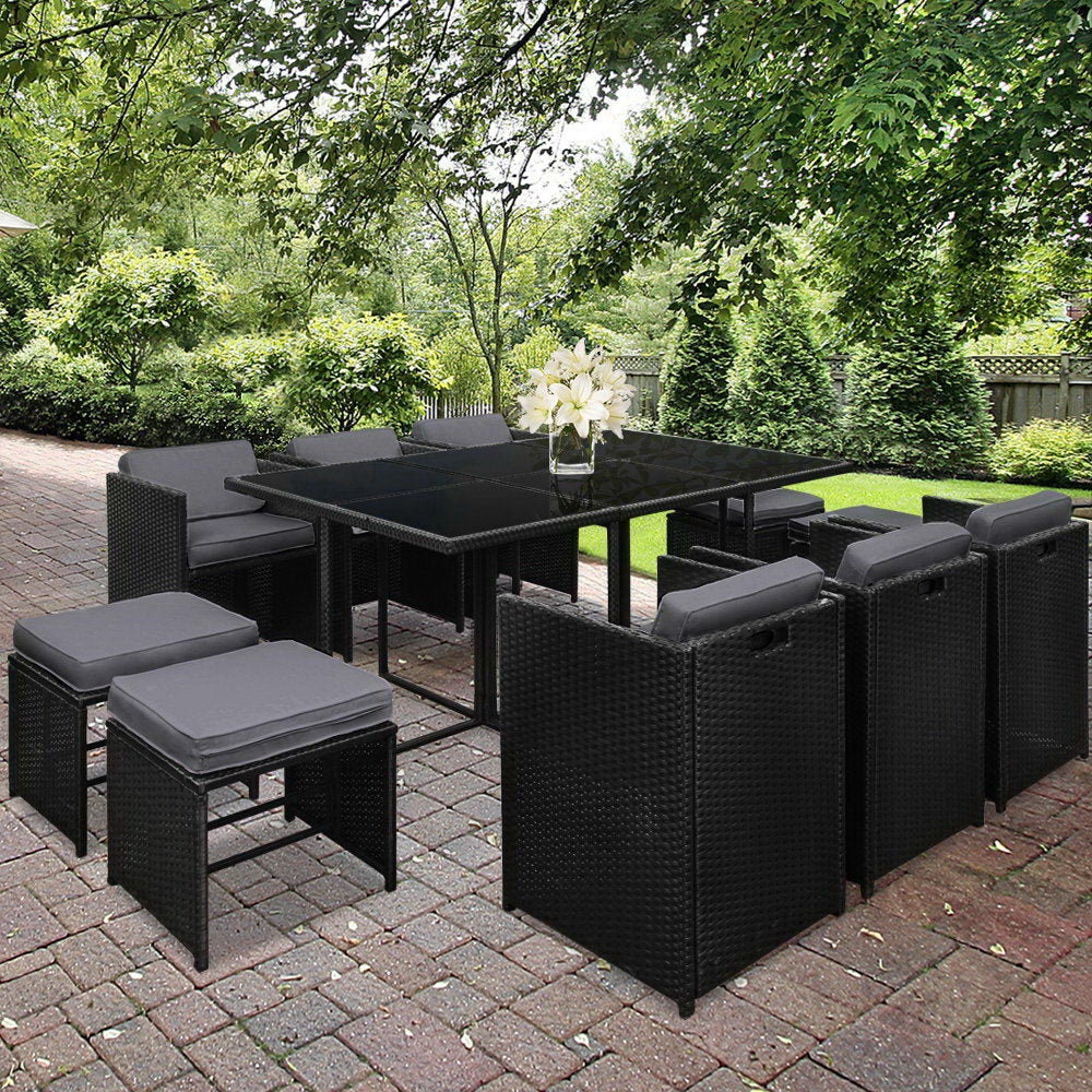 Gardeon 11 Piece PE Wicker Outdoor Dining Set in Black with grey cushions, featuring a glass top table and stylish design.